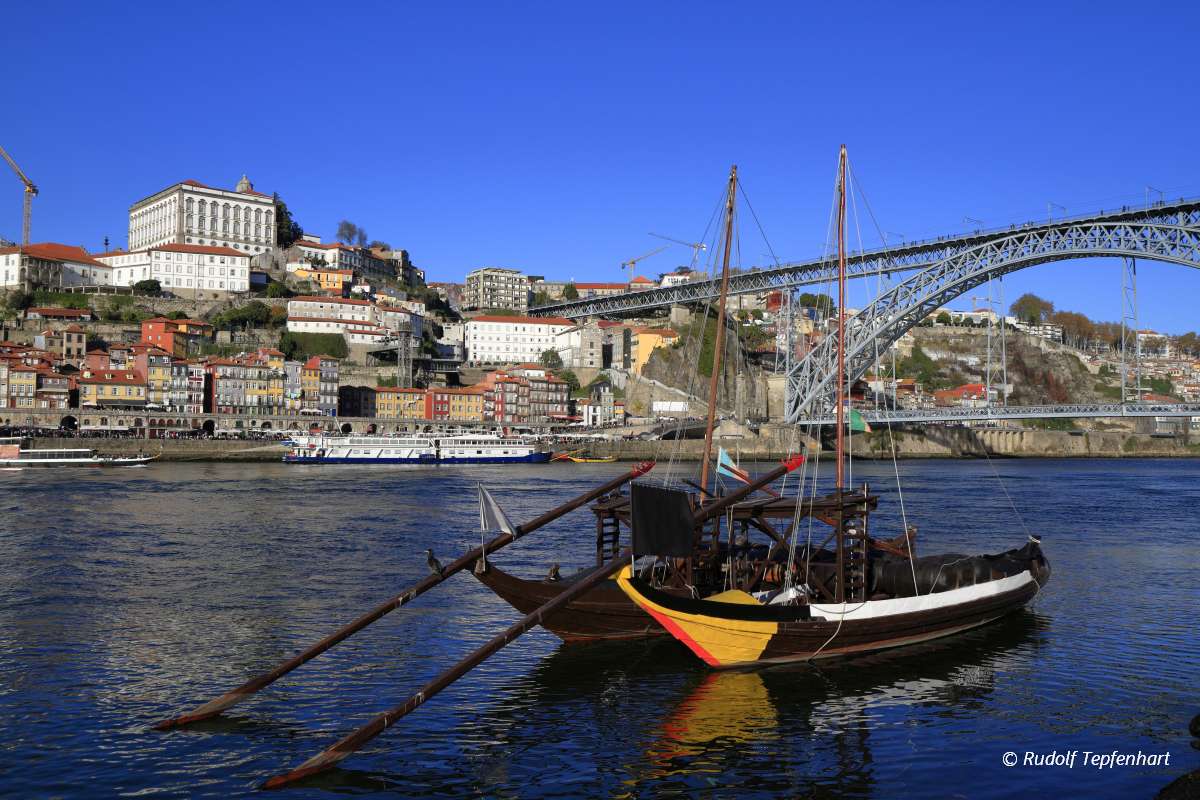 Traditional rabelo boats, Porto city skyline, Douro river and an